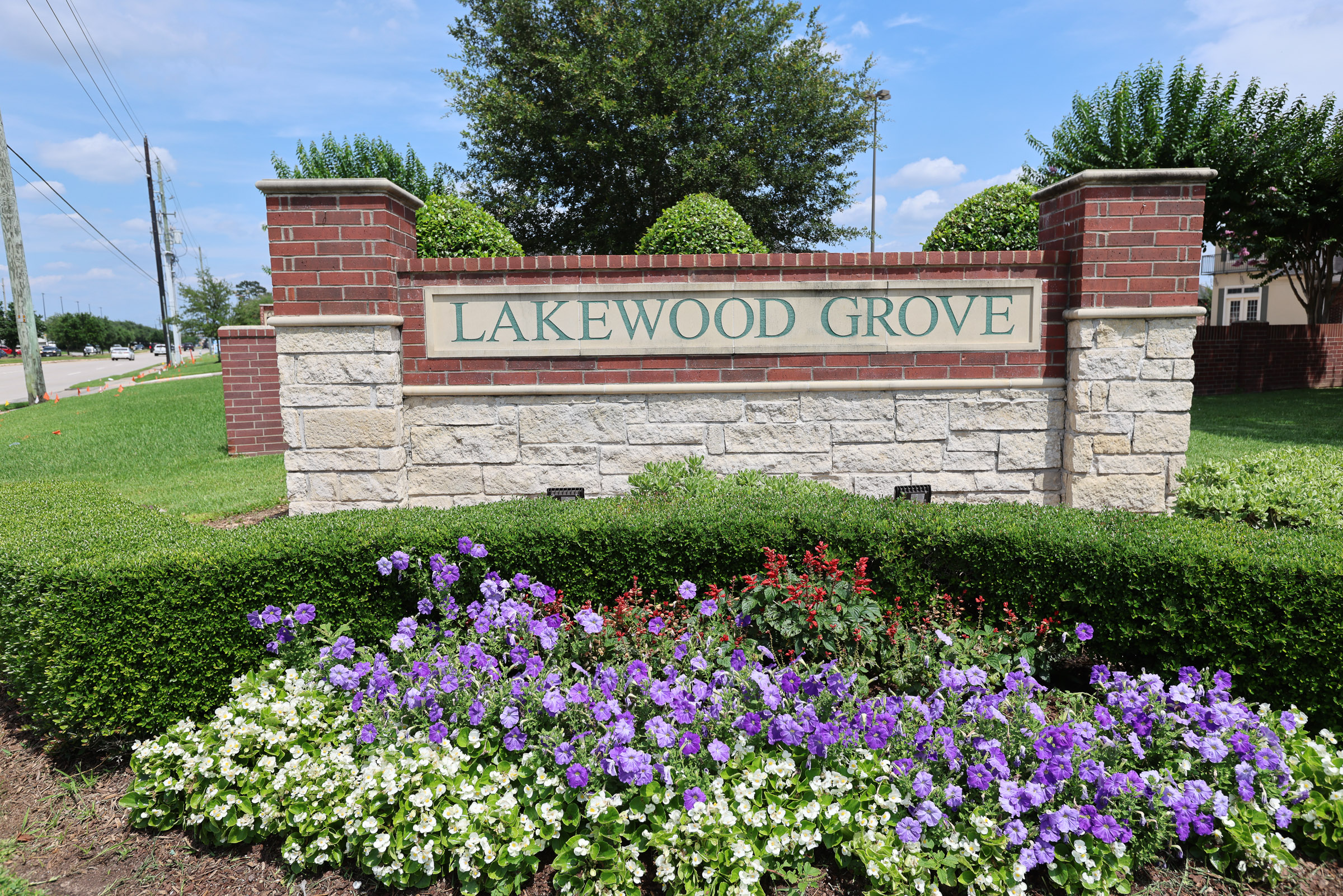 HOA entry monument with colorful flower beds