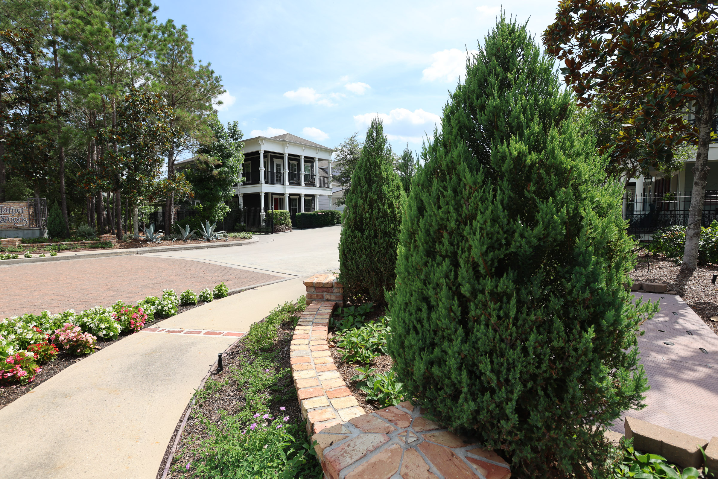 Community entrance walkway with maintained beds