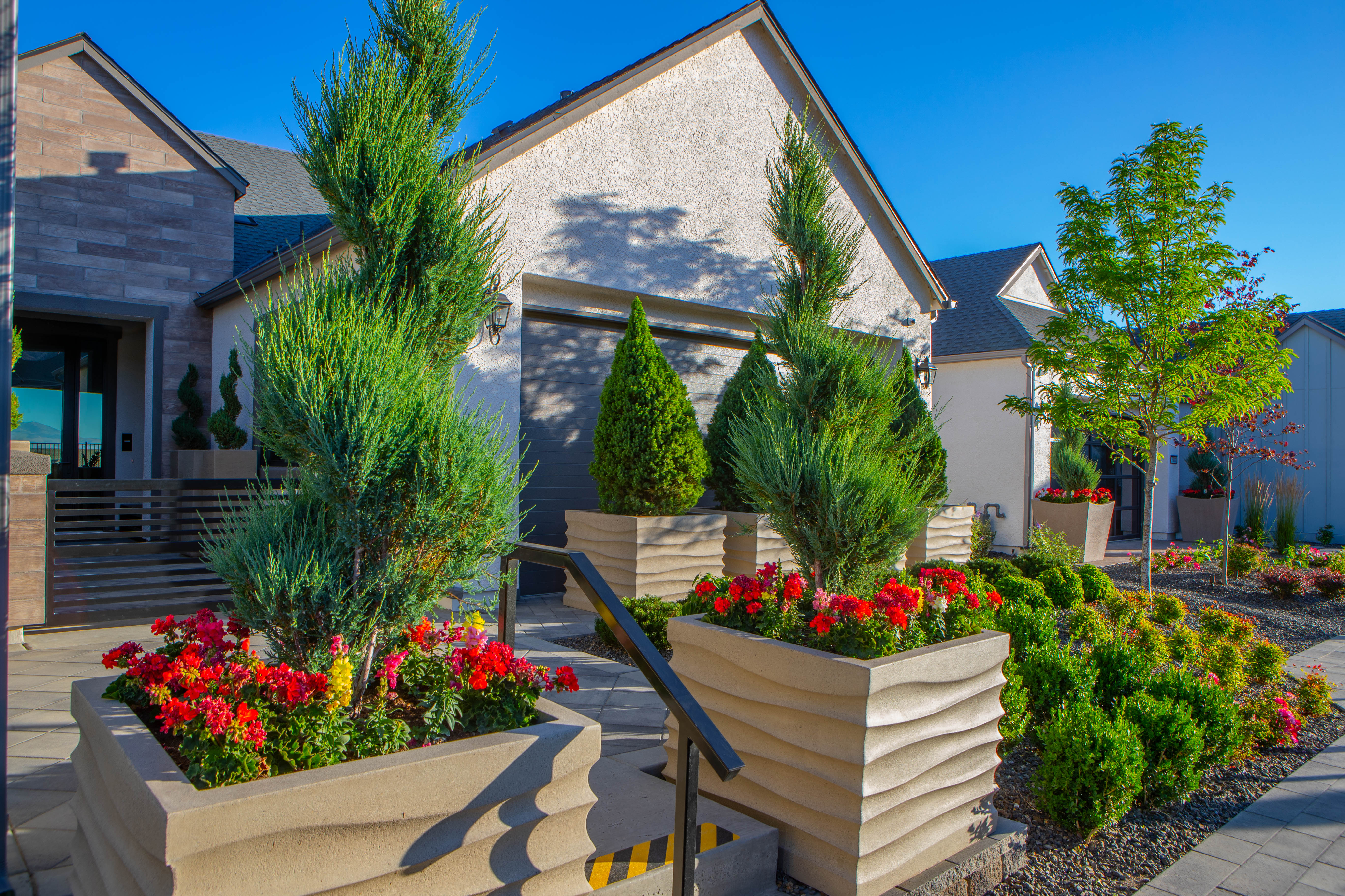Building entry landscaping with planters and maintained beds